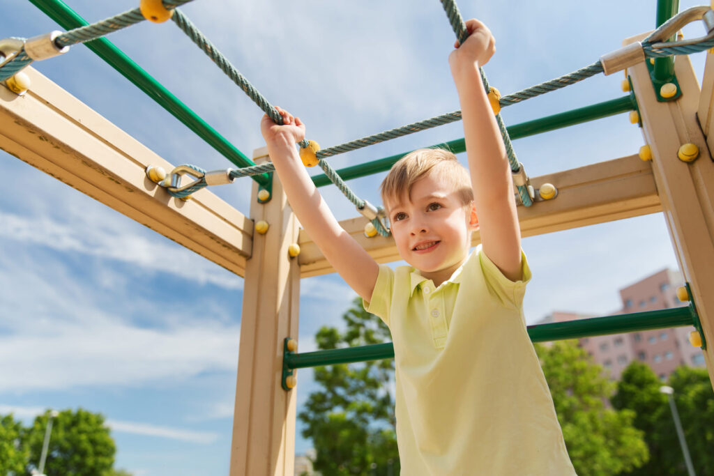 happy-little-boy-climbing-on-children-playground- chiropractic support for children