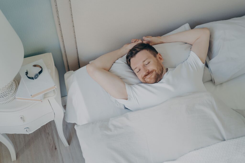 young-happy-relaxed-caucasian-man-sleeping-in-bed young-happy-relaxed-man-sleeping-in-bed