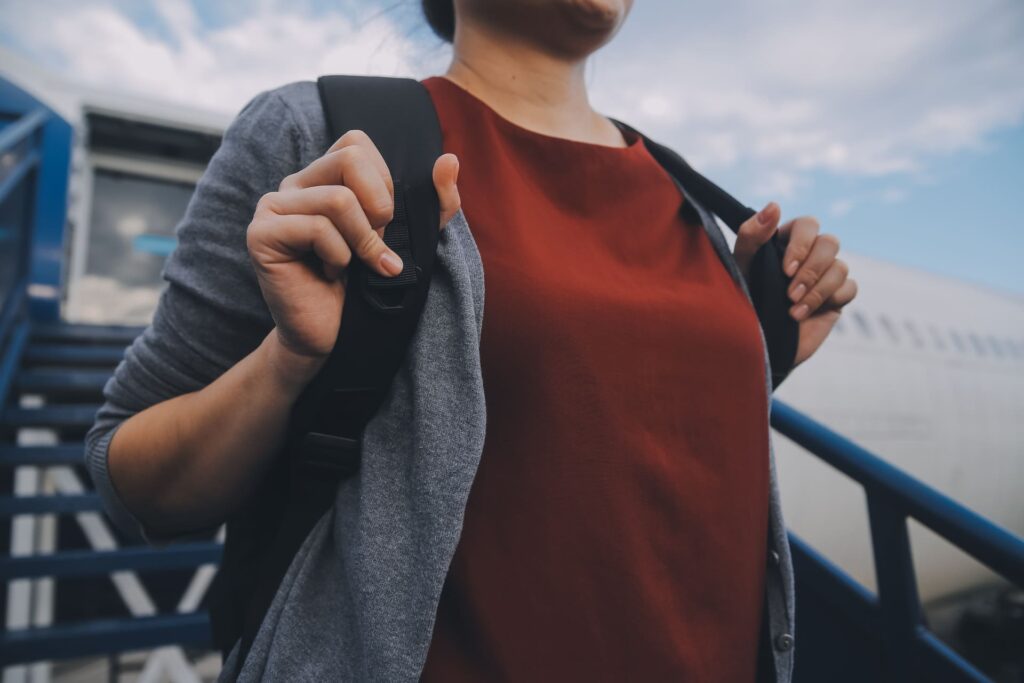 happy-woman-traveler-with-backpack